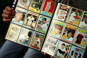 A man sells vintage baseball sports cards prior to the start of a game