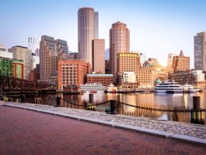 The Boston Harbor and Financial district in Boston, Massachusetts, USA at sunrise showcasing its mix of contemporary and historic buildings.