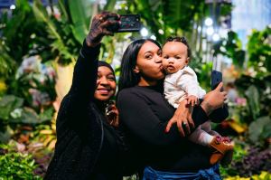 two women and a baby enjoying the flower show