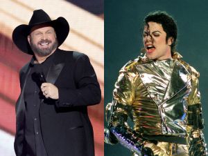 Garth Brooks Wants To Cover Michael Jackson. On stage, Garth is in a black suit and cowboy hat, and Michael is in a gold outfit.