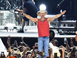 Kenny Chesney Wrapped His Tour Rehearsals - Kenny on stage wearing a red tank top.