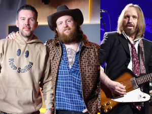 Brothers Osborne Will Cover Anthem On Tom Petty Tribute - TJ Osborne In a brown hoodie and John Osborne in a hat and blue plaid shirt, Tom Petty performing wearing a black jacket and red tie.