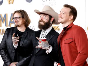 Post Malone Sings A Garth Brooks Classic - HARDY, Post Malein in black, and Morgan Wallen in a maroon jacket.