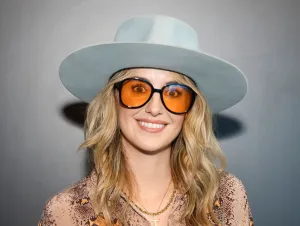 Lainey Wilson Feels Responsible - Lainey in a tan patterned shirt a hat and sunglasses