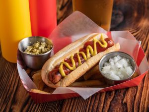 Scrumptious hot dog with mustard. This story is about the best Massachusetts hot dog spot, according to the Food Network.