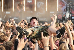 Heavy metal music fans hold aloft a fellow fan during a performance by thrash band Frei.Wild on the first day of the Wacken Open Air heavy metal music fest on August 4, 2011 in Wacken, Germany. Approximately 75,000 heavy metal fans from all over the world have descended on the north German village of 1,800 residents for the annual three-day fest.