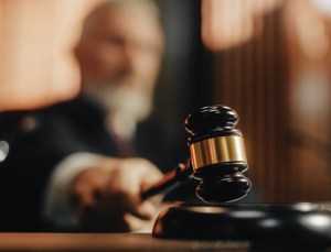 Court of Law and Justice Trial Session: Imparcial Honorable Judge Pronouncing Sentence, striking Gavel. Focus on Mallet, Hammer. Cinematic Shot of Dramatic Not Guilty Verdict. Close-up Shot.