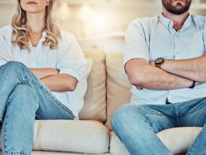 couple fighting and giving each other the silent treatment. Caucasian man and woman sitting on the sofa with their arms folded after an argument. Unhappy husband and wife ignoring each other, avoidable fights that can ruin relationships