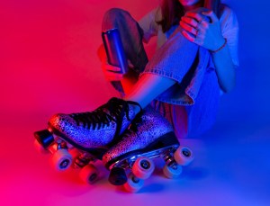 Roller skater holding a soda drink in a can during rest. Skating - sports and recreation. Saturated pink and blue, pop art style poster.