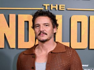 Pedro Pascal attends 'The Forge' experience inspired by the Star Wars series The Mandalorian, to celebrate the launch of The Mandalorian Season 3 wearing a brown sweater and mustache, All The Ways Pedro Pascal Is A Zaddy.