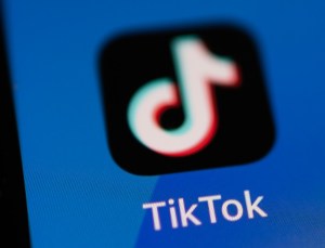 In this photo illustration, the TikTok app logo is displayed on an iPhone