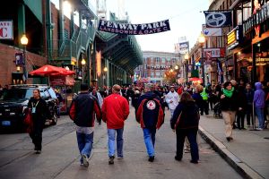 Fans walk outside Fenway Park in Boston prior to a Red Sox game. You can have an affordable Fenway Park experience for under $100.