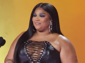 Lizzo speaks onstage during the 66th GRAMMY Awards facing left slightly smiling wearing a strapless leather dress, Lizzo Declares: 'I Quit' In Cryptic Social Media Post.