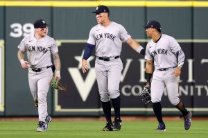 Alex Verdugo #24, Aaron Judge #99, and Juan Soto #22 of the New York Yankees celebrate after defeating the Houston Astros at Minute Maid Park where the Yankees new uniforms were debuted.