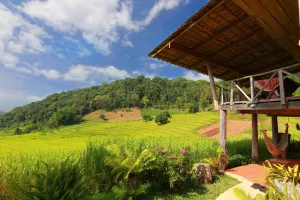 Farmside resort with green grass and hills on a sunny day. New England hotels is one of the most expensive in the country.