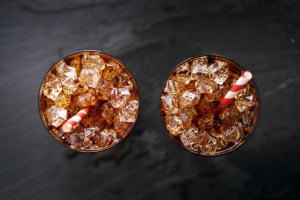 iced cola soda pop with straw in flay lay composition. new fast-food soda chain