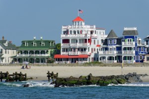 Cape May Beach with New Jersey hotels on a sunny day by the water.