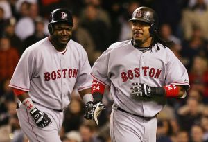 Manny Ramirez #24 and David Ortiz #34 of the Boston Red Sox celebrate after scoring against the New York Yankees. Both will be at opening day at Fenway Park in 2024.