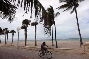 Florida Man riding his bike on the beach. A naked drunk Florida Man was found in a garbage can.