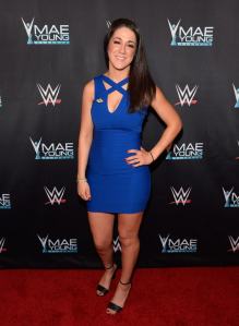 WWE: Mae Young in a blue outfit on a red carpet
