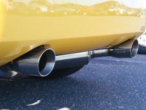 dual exhaust tips on a yellow sports car