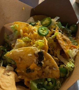 A nacho platter with chips, rice, cheese, and jalapenos from the South Shore Taco Guy restaurant.