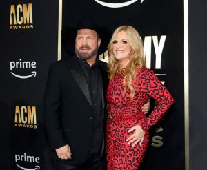 Garth Brooks in black and Trisha Yearwood in red and black at the ACM Awards.