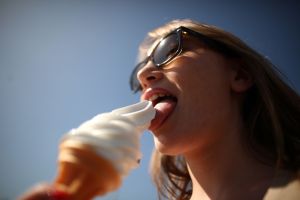 Woman licking an ice cream cone. Are Ice Cream Nachos the new summer treat?