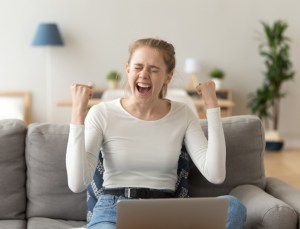 Euphoric young woman celebrating college acceptance