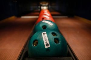 Bowling balls at a bowling alley. Woman throws bowling balls during fight at alley