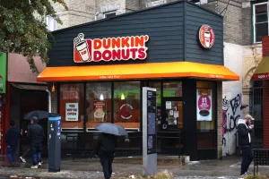 People walk past a Dunkin' store in New York City. Dunkin' released the new Wicked Lahhhge Tumbler