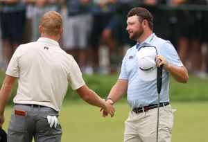 Travis Vick of the United States and Matthew NeSmith of the United States shake hands on the 18th green. Travis Matthew makes the best golf shirt ever accordingly.