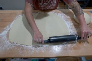 Baker making cinnamon rolls. Florida Woman Arrested For Throwing A Cinnabon Roll At A Man