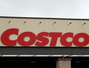 A Costco sign hangs over the entrance to a wholesale store