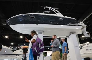 People walk past a Cobalt boat on display at the 2024 Discover Boating show. Georgia Boat Show.