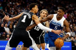 Anthony Edwards #5 of the Minnesota Timberwolves drives to the basket against Victor Wembanyama #1 of the San Antonio Spurs. Both are popular young nba stars