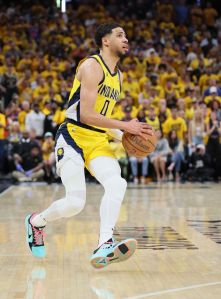 Tyrese Haliburton #0 of the Indiana Pacers dribbles the ball wearing light blue NBA basketball sneakers
