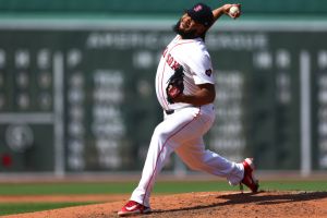 Kenley Jansen #74 of the Boston Red Sox throws against the Milwaukee Brewers during the ninth inning at Fenway Park. He is one of the pro athletes holding camps this summer