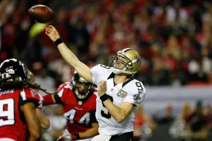 Drew Brees #9 of the New Orleans Saints throws a pass during the second half against the New Orleans Saints at the Georgia Dome. The Picklr is backed by Brees.