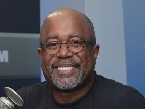 Darius Rucker smiling in a black shirt.