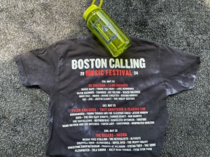Boston Calling merch the back of the t-shirt with a yellow water bottle up top.