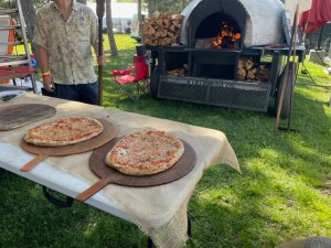 Pizza cooked fresh is something to eat at Boston Calling in 2024. On a peel on a table.