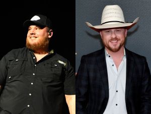 Luke Combs is onstage in black, and Cody Johnson is in a cowboy hat and blue blazer.