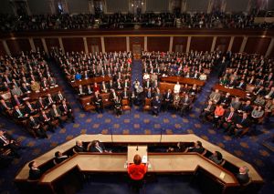 The floor of the House Of Representatives. Congressman's kid hilariously makes faces in the background of his speech!