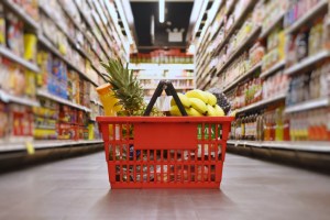 Grocery basket with products such as fruit and juice. New market basket grocery store