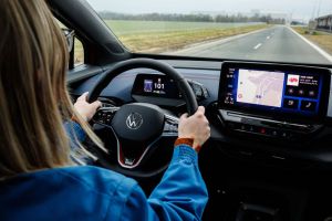 Woman driving a car. Putting your feet up on the dashboard can be very dangerous!