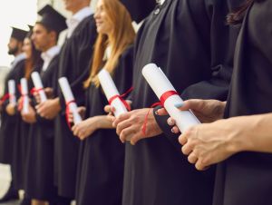 Graduates standing in a line. The numbers are in and research has been conducted, and now, we have information on North Carolina high school graduation rates and how they stack up to other states.