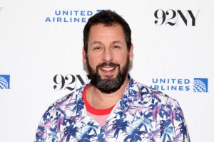 Adam Sandler attends Netflix's "Hustle" screening in front of a step and repeat. Happy Gilmore 2 filming starts soon.