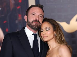 Ben Affleck and Jennifer Lopez attend the Los Angeles premiere of Amazon MGM Studios "This Is Me...Now: A Love Story", ben wearing a suit and tie smiling looking up, while jennifer wears a strapless black gown smiling, leaning on ben with her eyes closed. Ben Affleck And Jennifer Lopez Selling $60 Million Home.