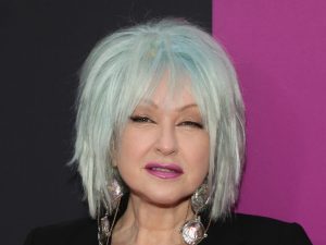 Cyndi Lauper attends "The Heart of Rock and Roll" celebration at James Earl Jones Theatre with blue short hair wearing a black blazer, Cyndi Lauper Announces Farewell Tour.